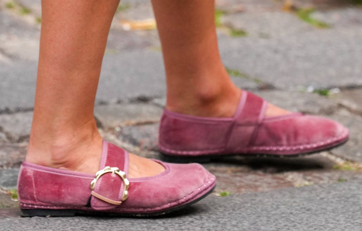 Lady Amelia Windsor embraces romantic-feminine glamour in the pink velvet Flabelus “Sophie” Mary Jane flats with a thick strap and a chunky scalloped gold-tone buckle