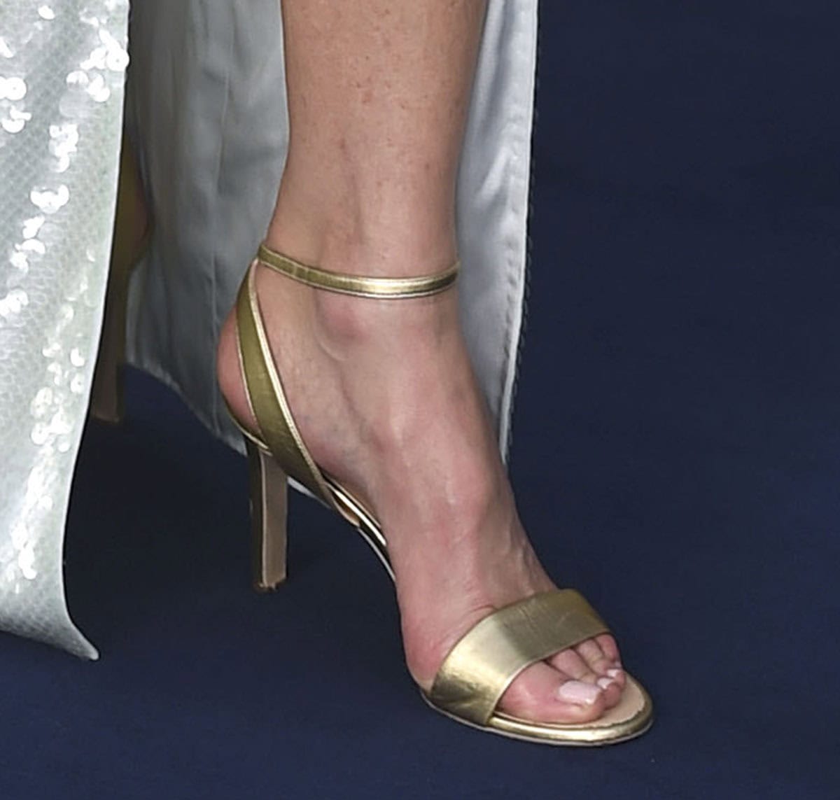 Nicole Kidman shines in her Chanel gold sandals with a wide strap across the toes and a slim ankle strap