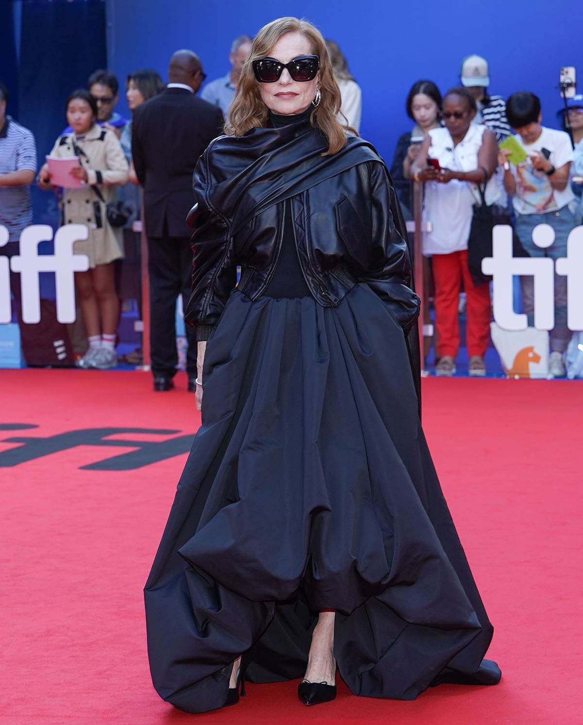 Isabelle Huppert wears an oversized black Balenciaga leather jacket, voluminous ball skirt, and sculptural black pumps on the TIFF 2026 red carpet