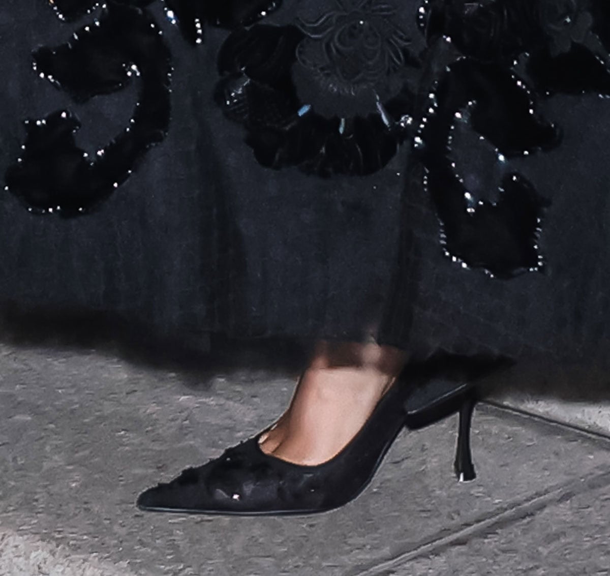 Jennifer Lopez wears black Dolce Gabbana lace slingback pumps with pointed toes and flared heels at Vogue World Milano 2026
