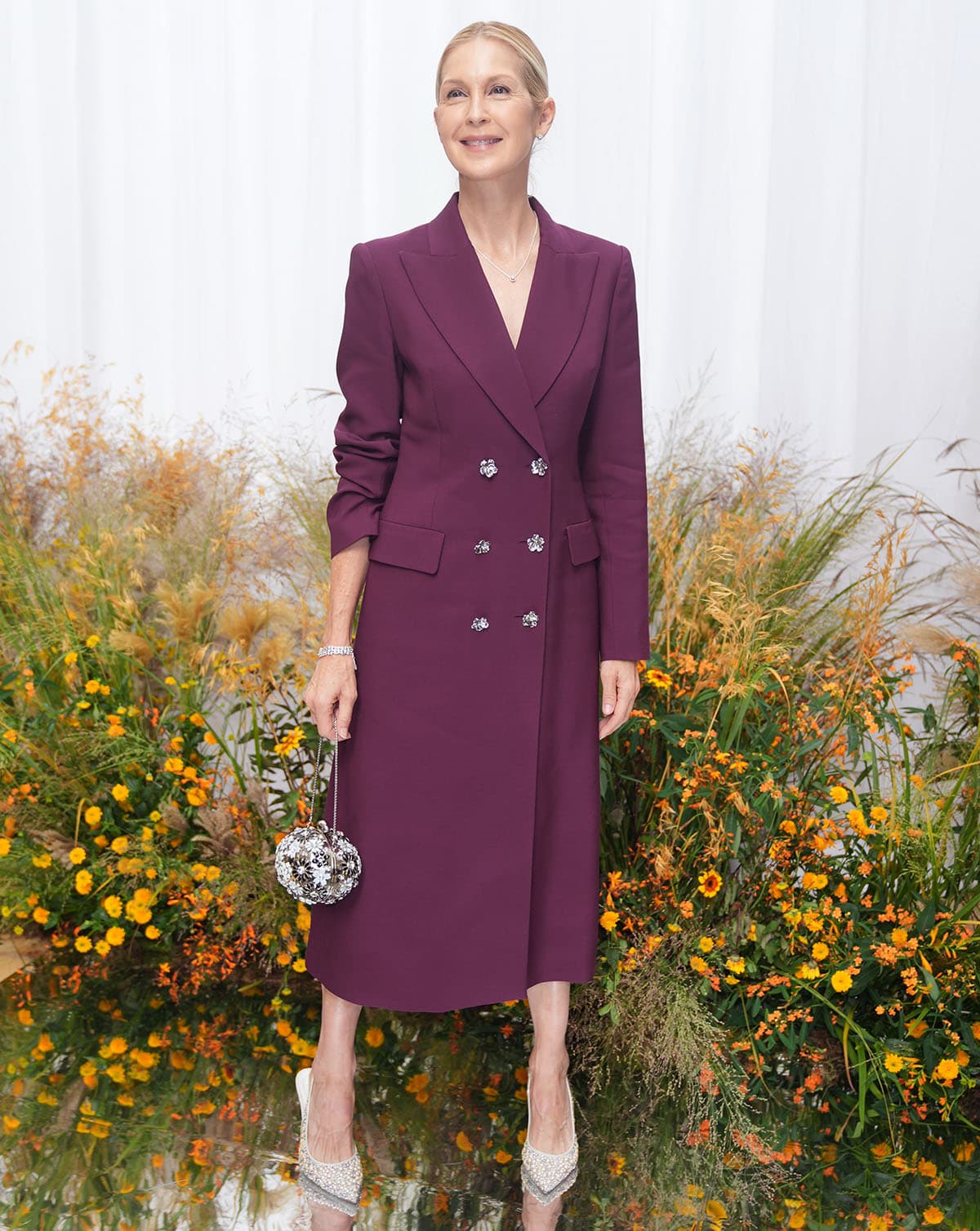 Kelly Rutherford wears a plum Patrick McDowell coat dress and René Caovilla pearl-embellished slingback pumps at London Fashion Week in September 2026