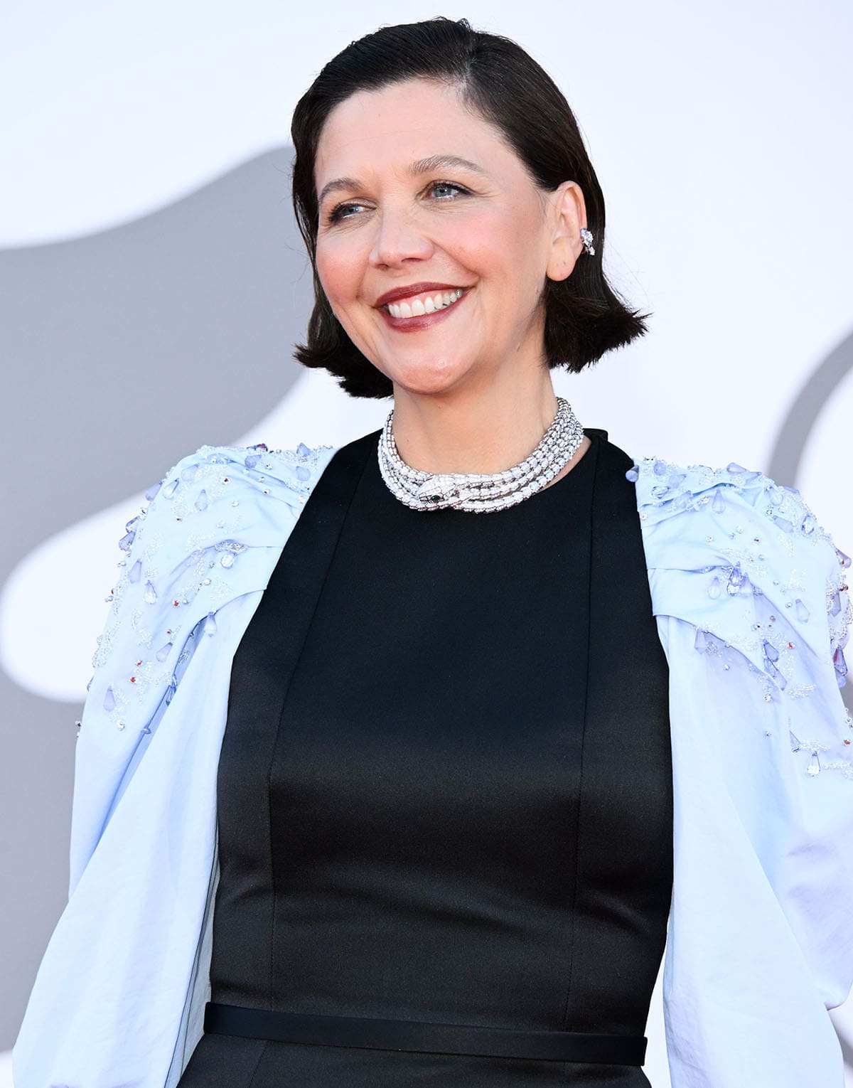 Maggie Gyllenhaal wears a Bulgari Serpenti High Jewelry diamond choker, Roman Wonders diamond earrings, and deep berry lipstick at the 2026 Venice Film Festival closing ceremony