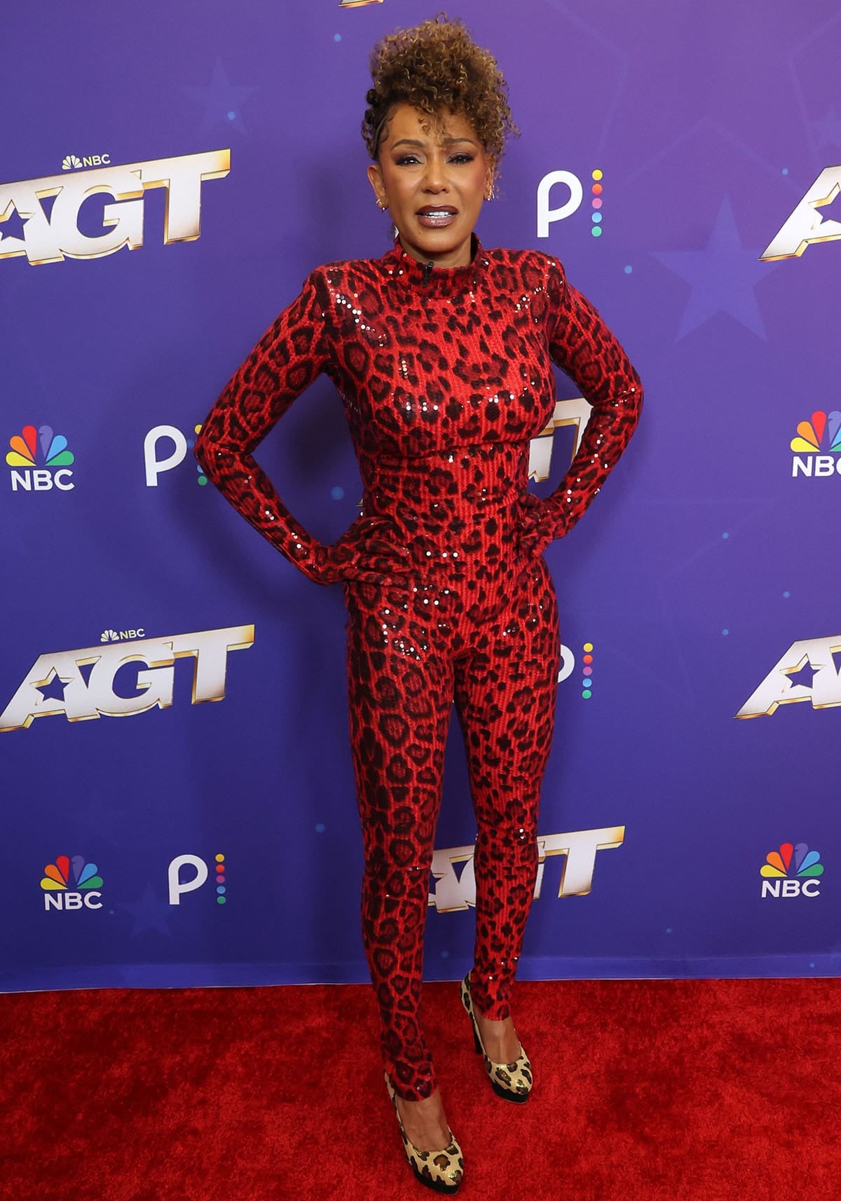 Mel B wearing a red-and-black sequined leopard Zuleyha Kuru catsuit with gold leopard Charlotte Olympia platform pumps at the AGT Season 21 semifinals