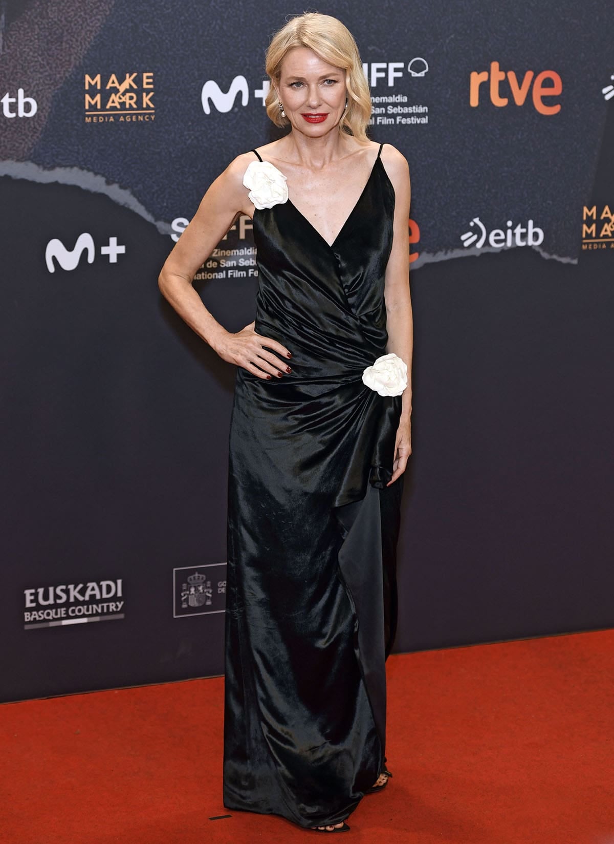 Naomi Watts wears a black velvet Dior gown with white floral appliqués and Dior Bow Slingback sandals at The Housewife screening in San Sebastián