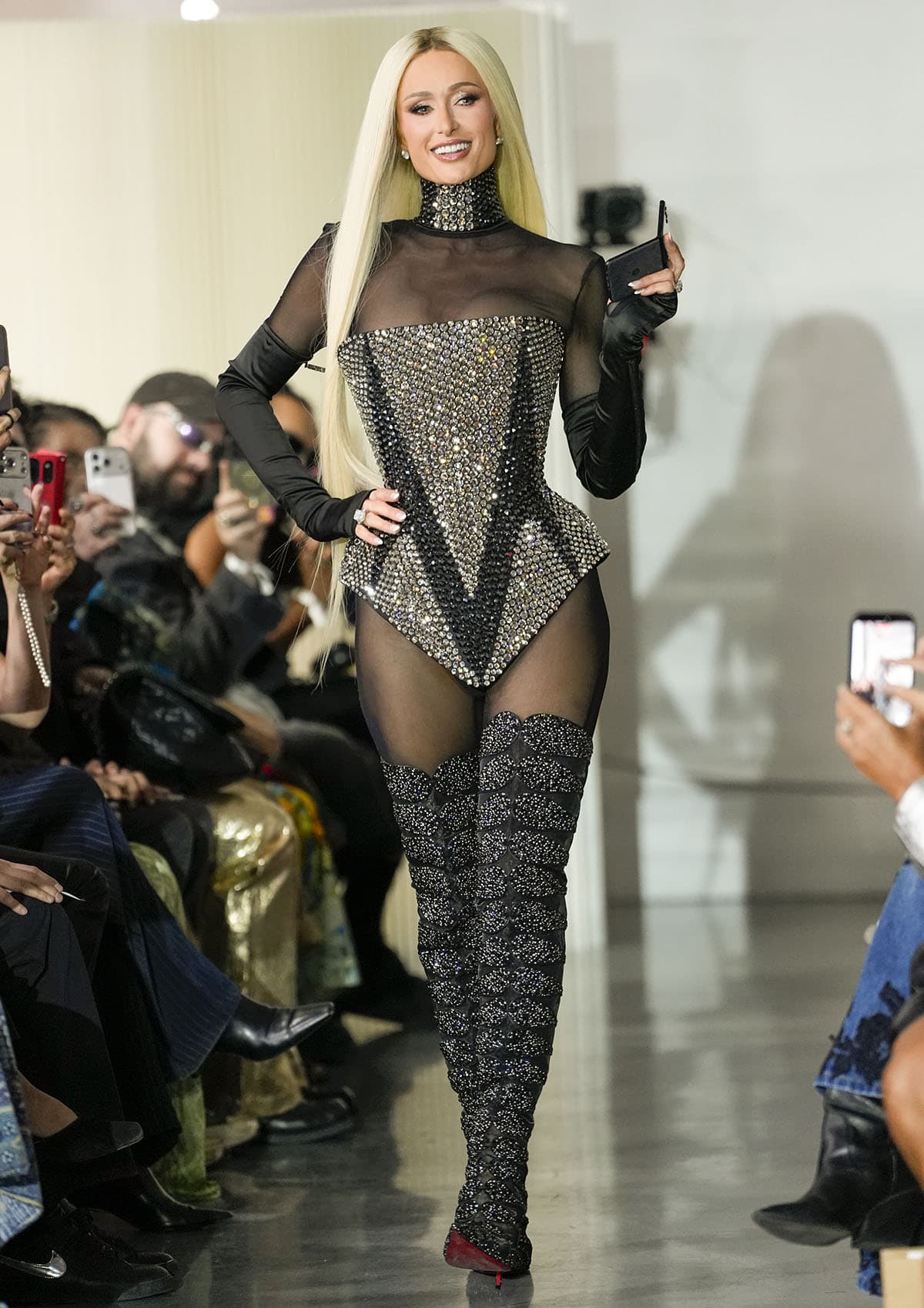 Paris Hilton in a crystal-covered The Blonds corset, sheer black catsuit, and Christian Louboutin thigh-high boots